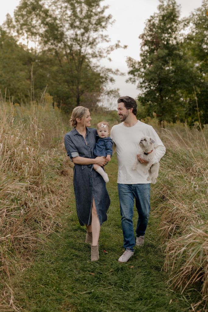 Hadley with her husband, daughter, and dog in a field