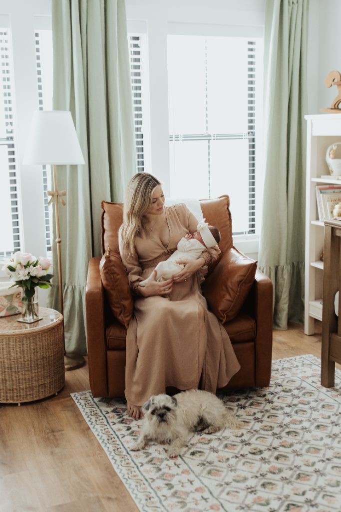 Hadley with baby Freya in a rocking chair